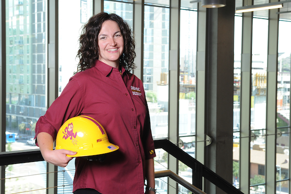 woman posing with construction hat