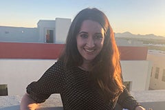 woman posing on balcony at sunset