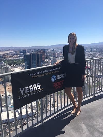 woman standing on balcony in city