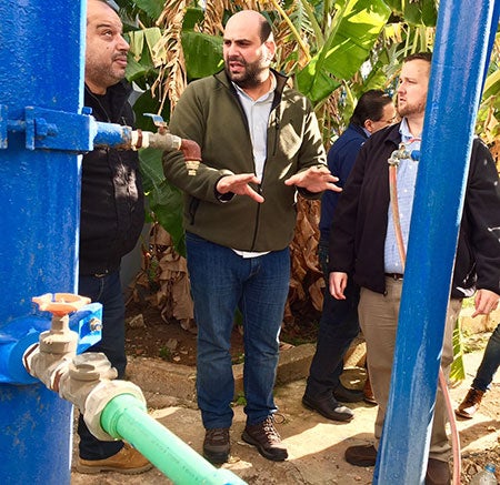 Men look at a well in Lebanon