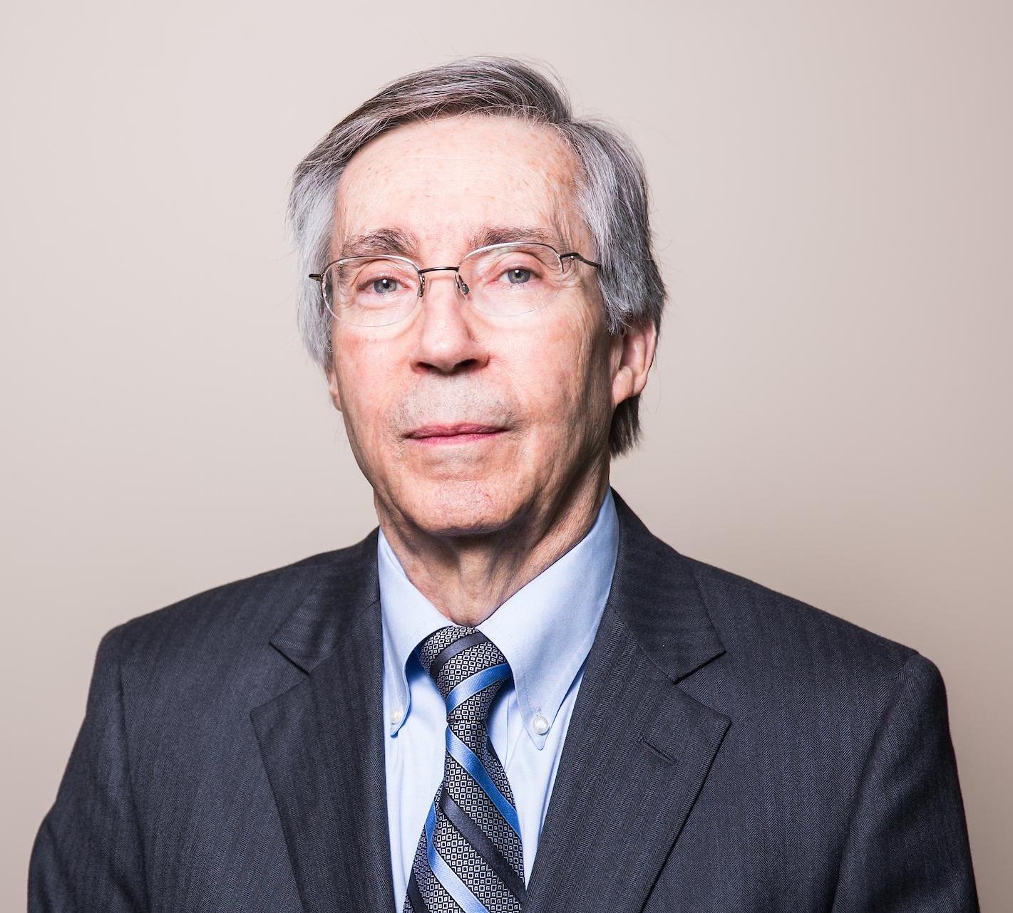 Man in blue suit and tie smiling