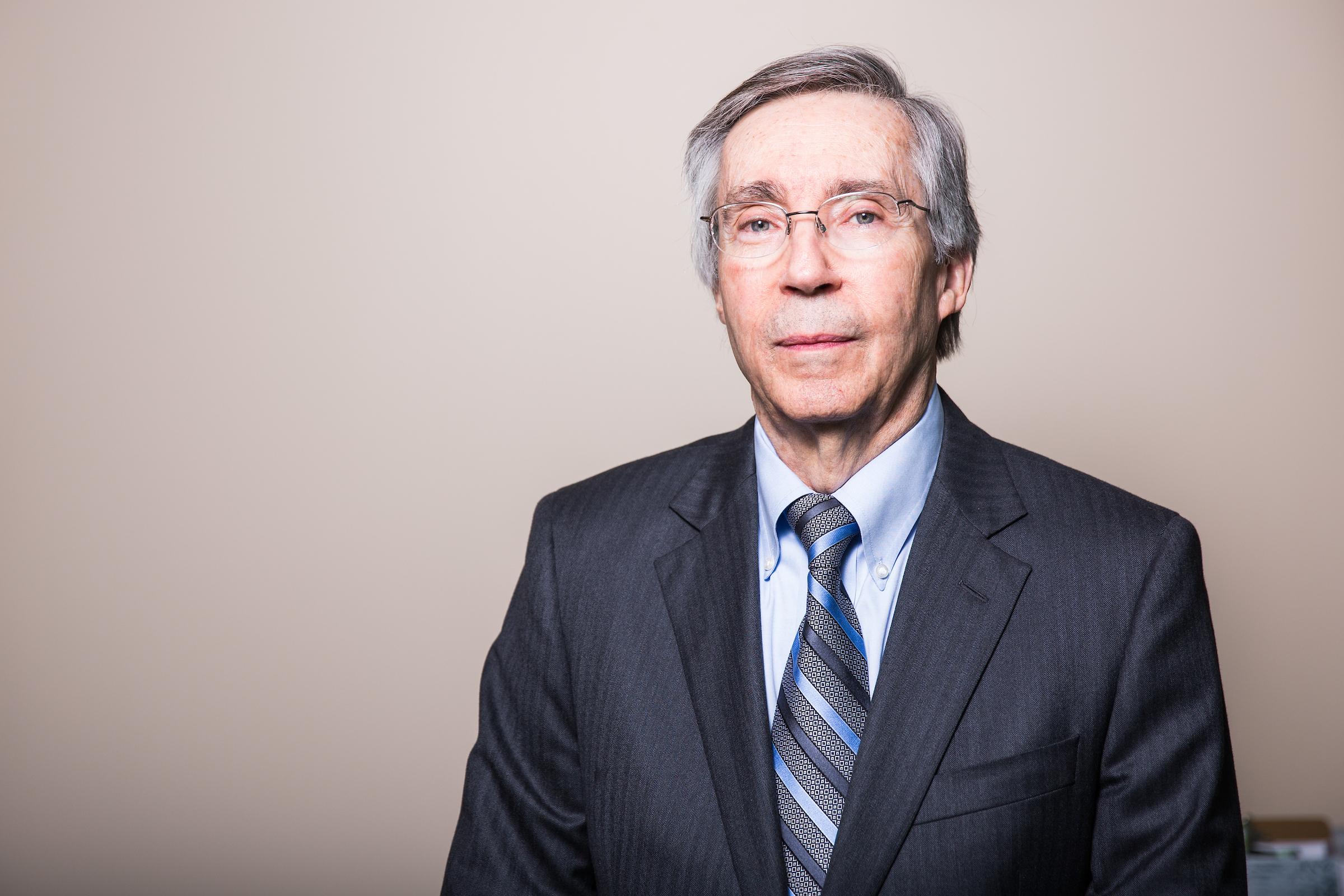 Man in black jacket and tie smiling