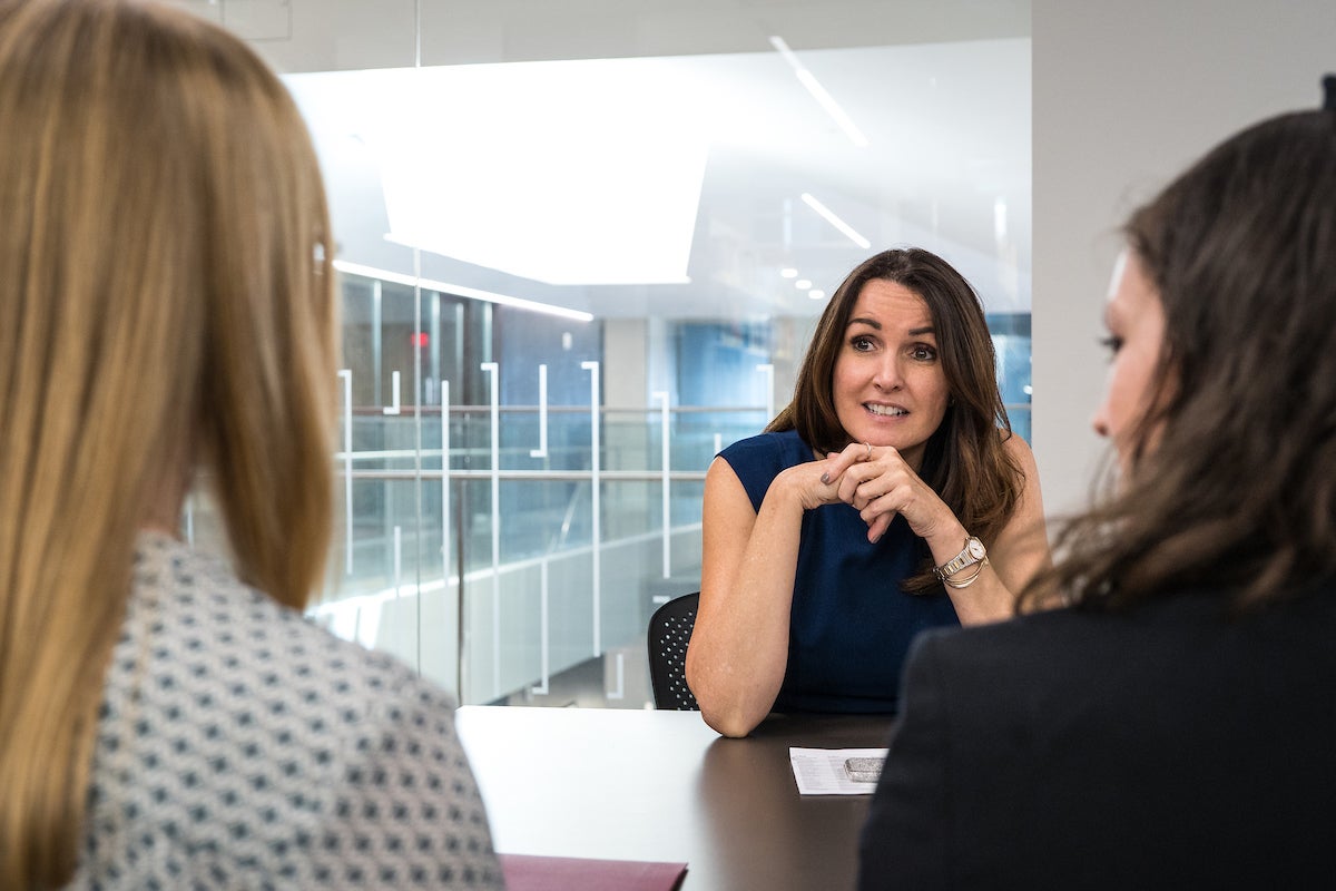 Woman meeting with students