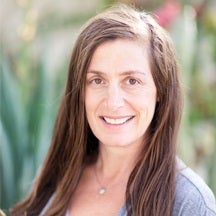 Woman with long brown hair and smiling