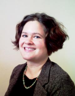 Woman in brown coat and necklace