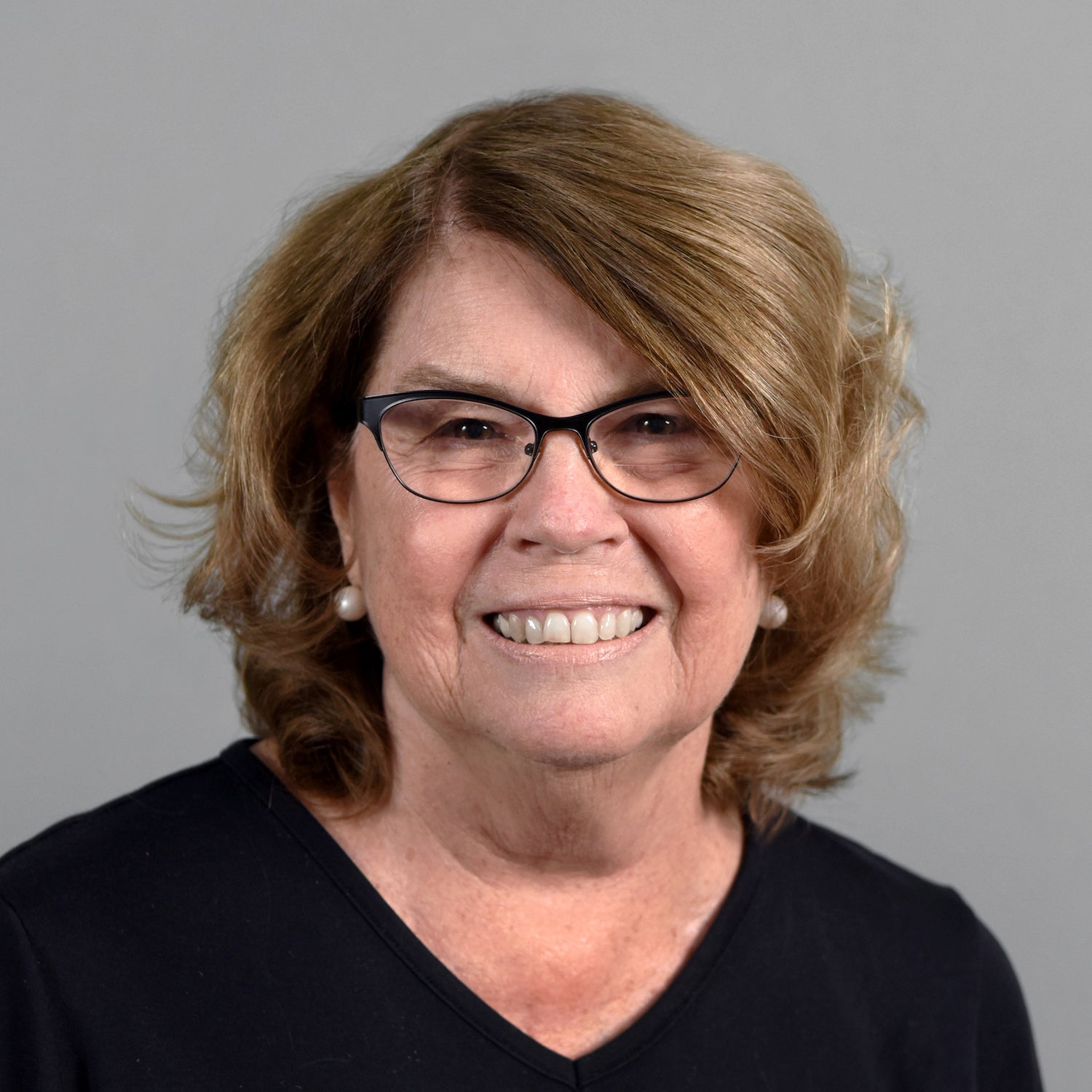 Woman with brown hair and glasses