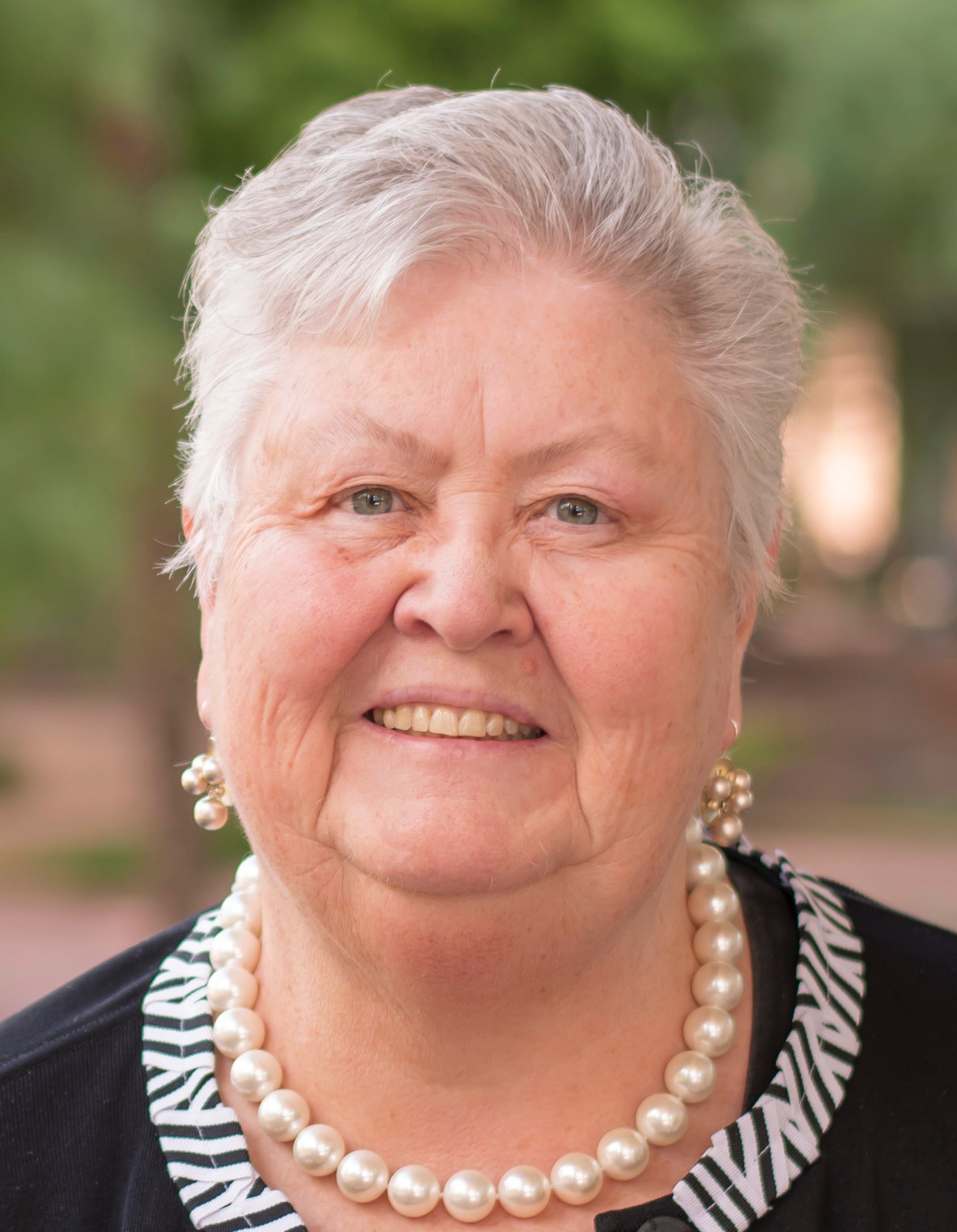 Woman with gray hair and smiling