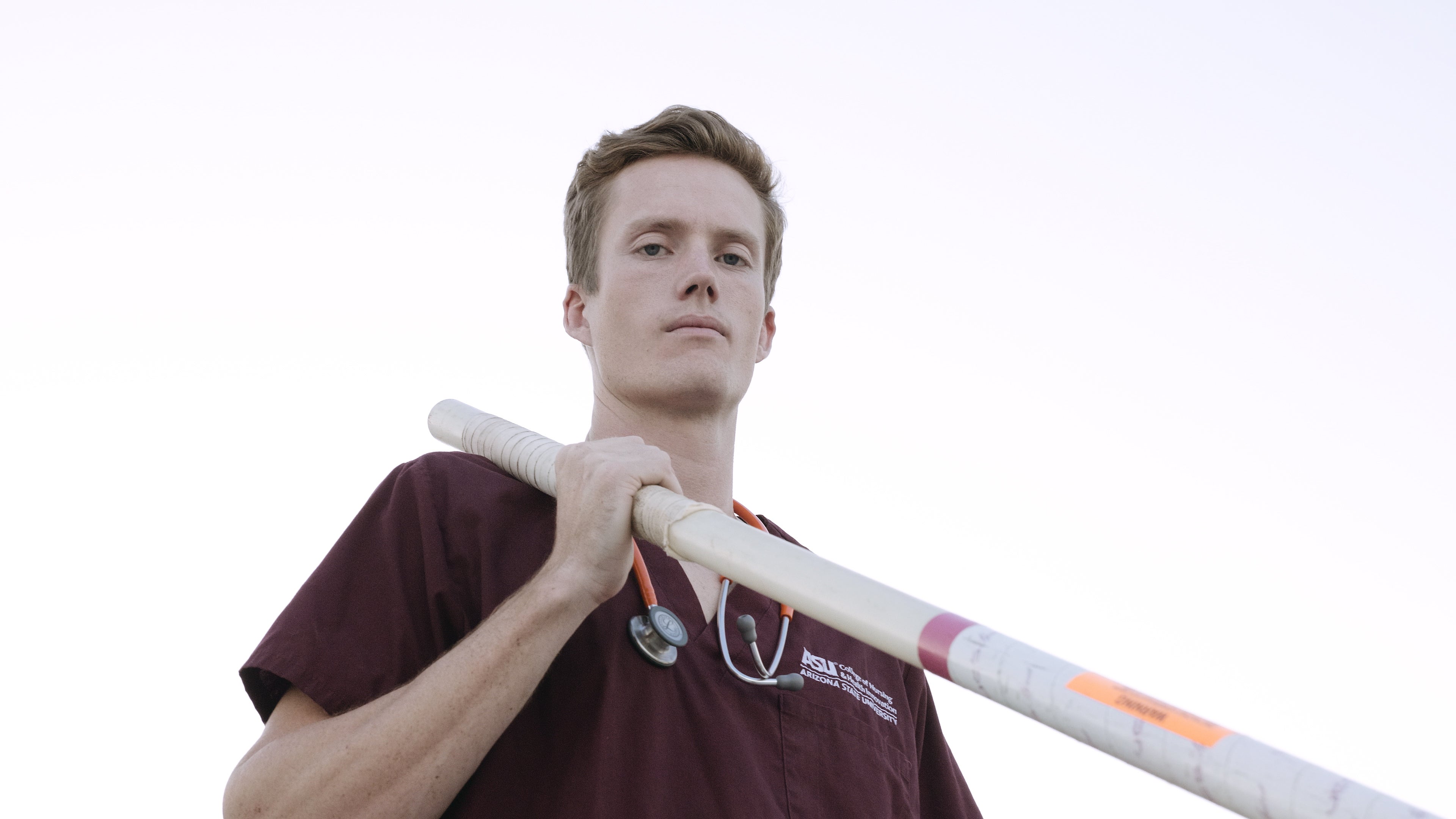 man holding pole vault