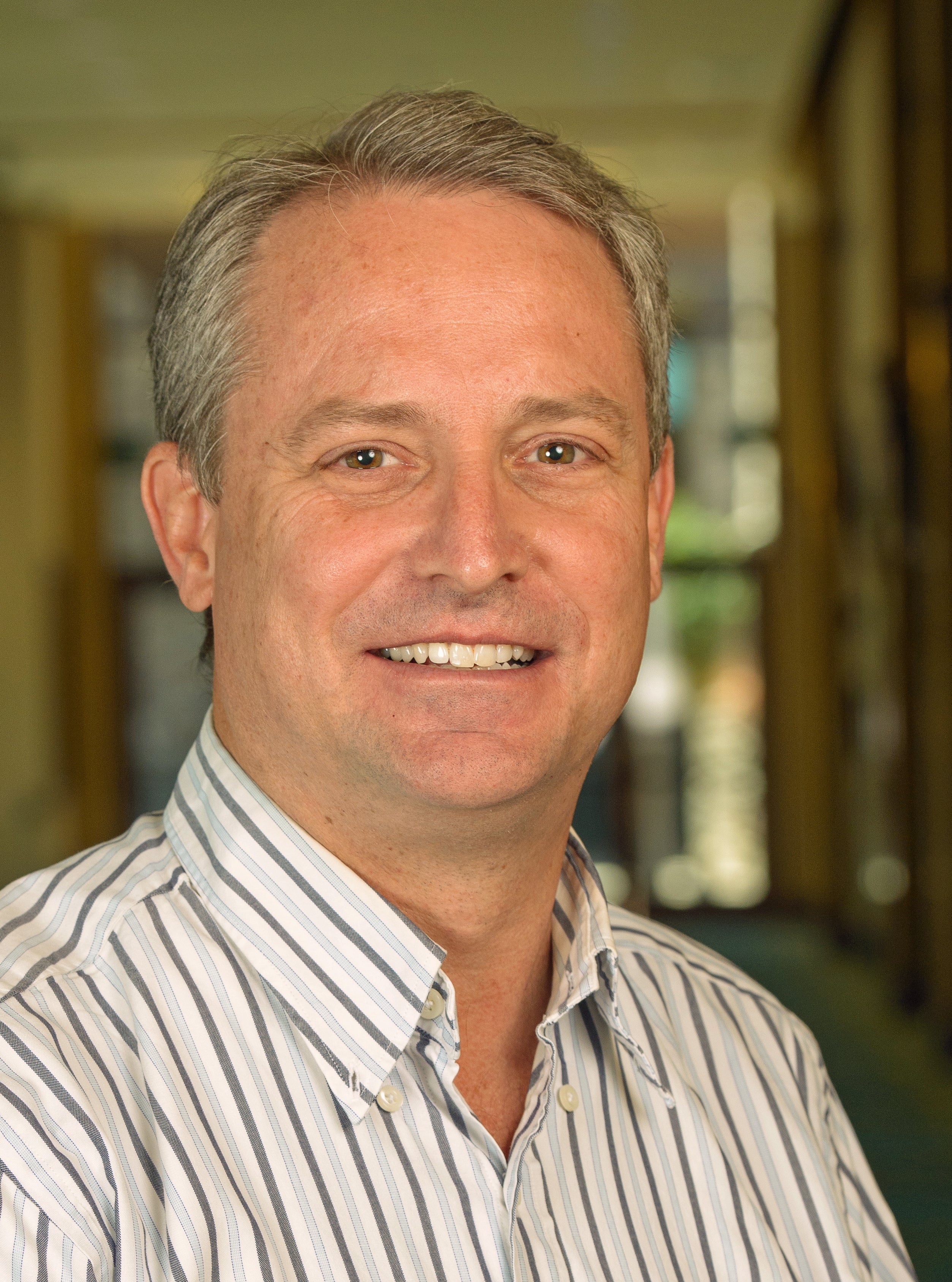 Man in striped shirt smiling