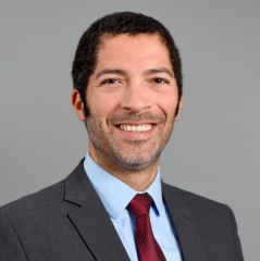 Man in red tie smiling