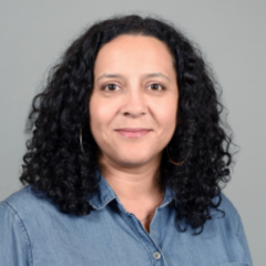 Woman with wavy hair and denim shirt