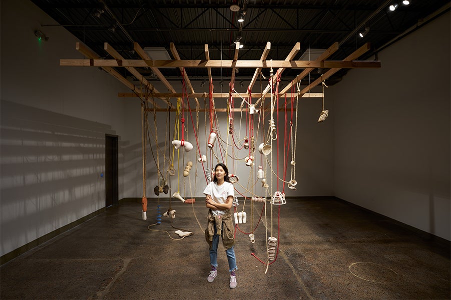 woman in front of ceramics exhibit