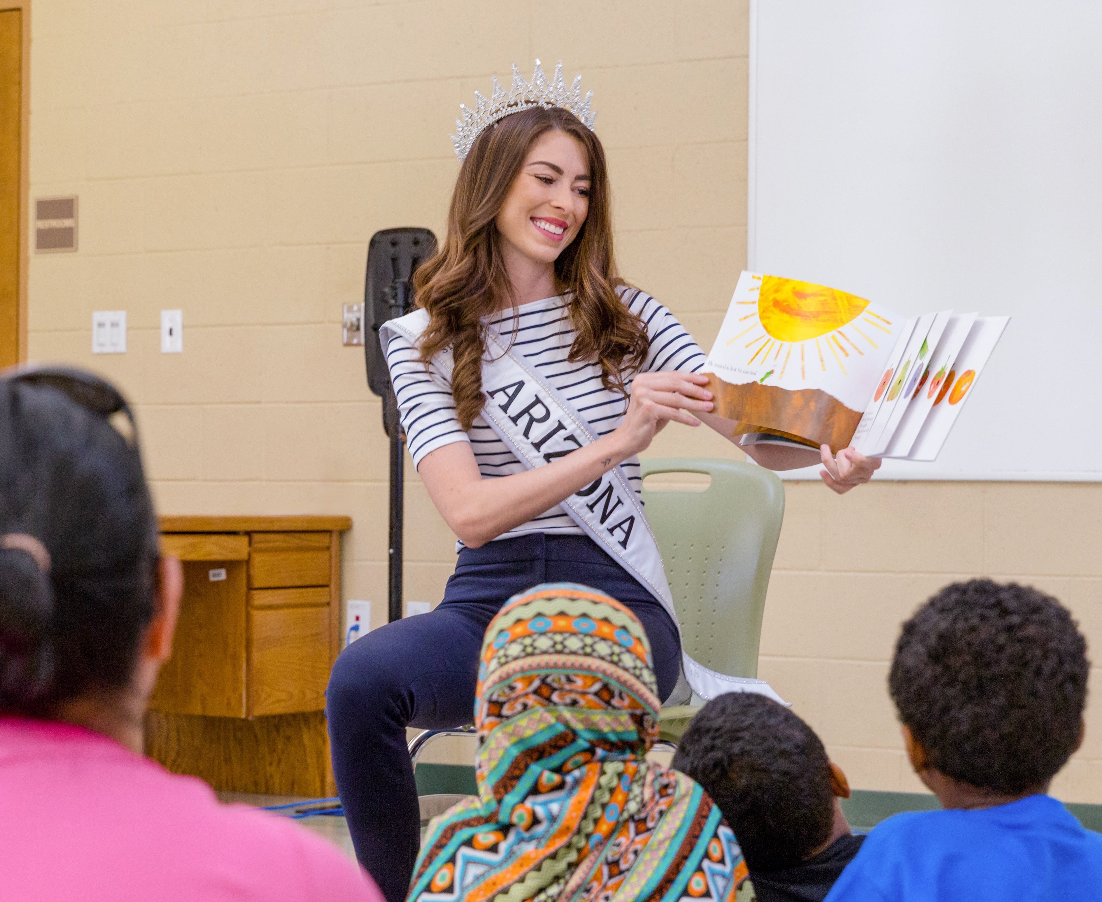 Woman reading to classroom