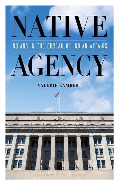 Photo of Department of the Interior building with U.S. and DOI flags atop pole. Title and author in blue sky above.