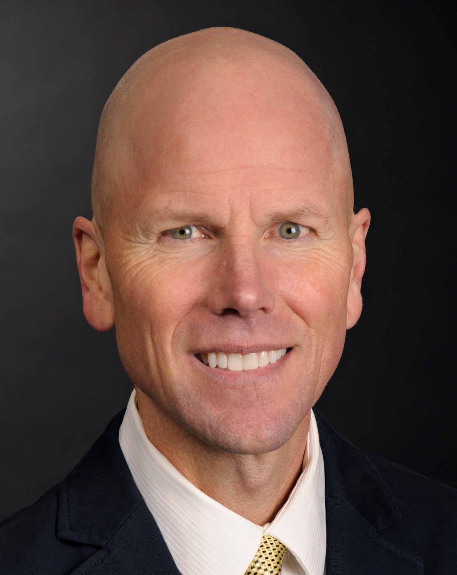 Man in suit and tie smiling