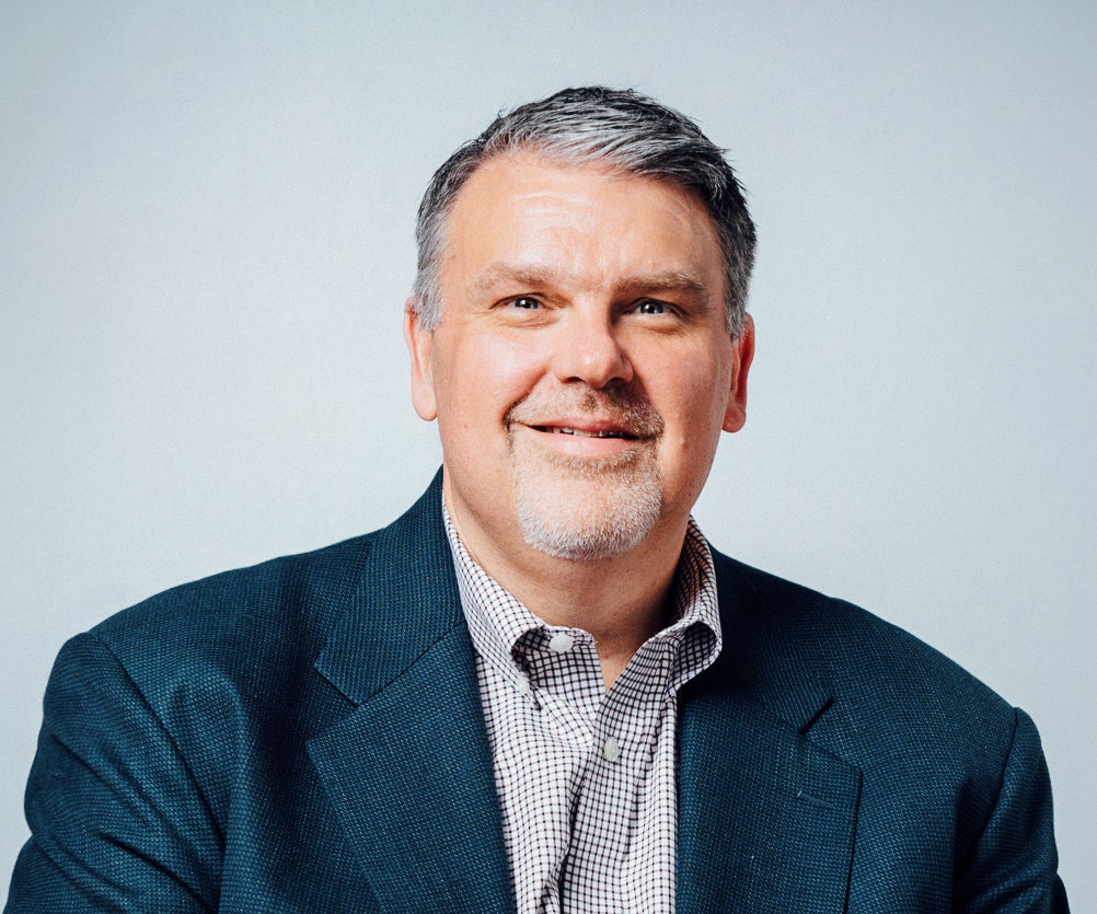 Man with gray hair and smiling