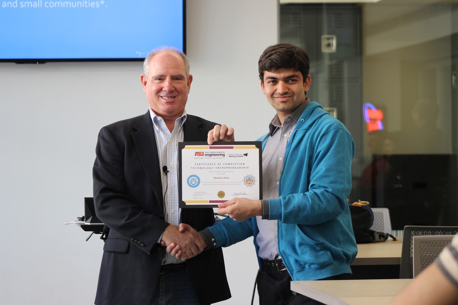 Pakistani scholar holding certificate