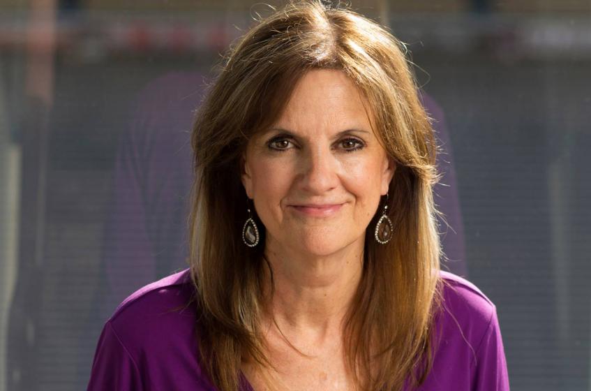 Woman with brown hair and purple shirt