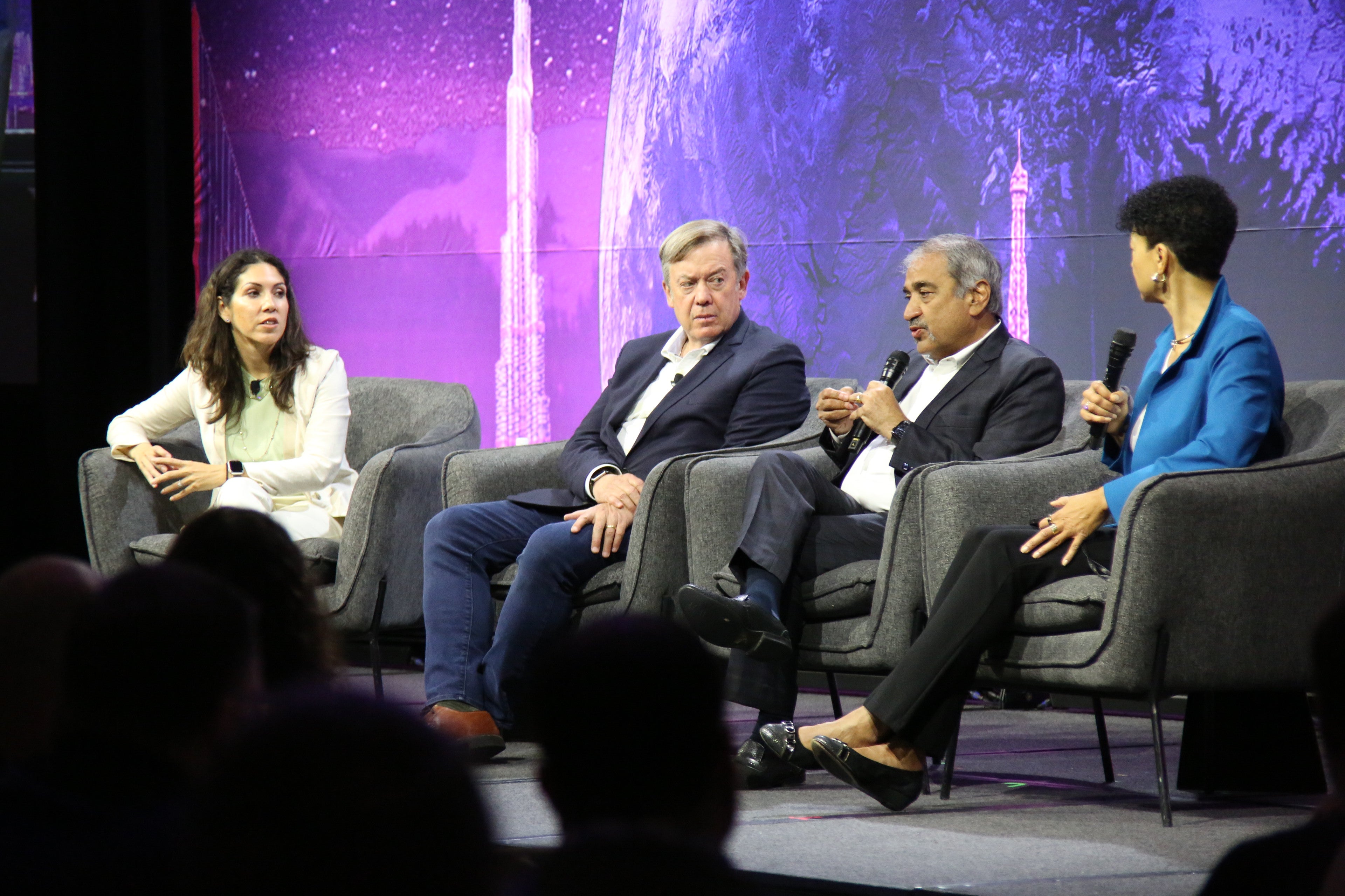 Four people sitting on stage for panel