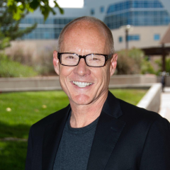 portrait of man with bald head and glasses