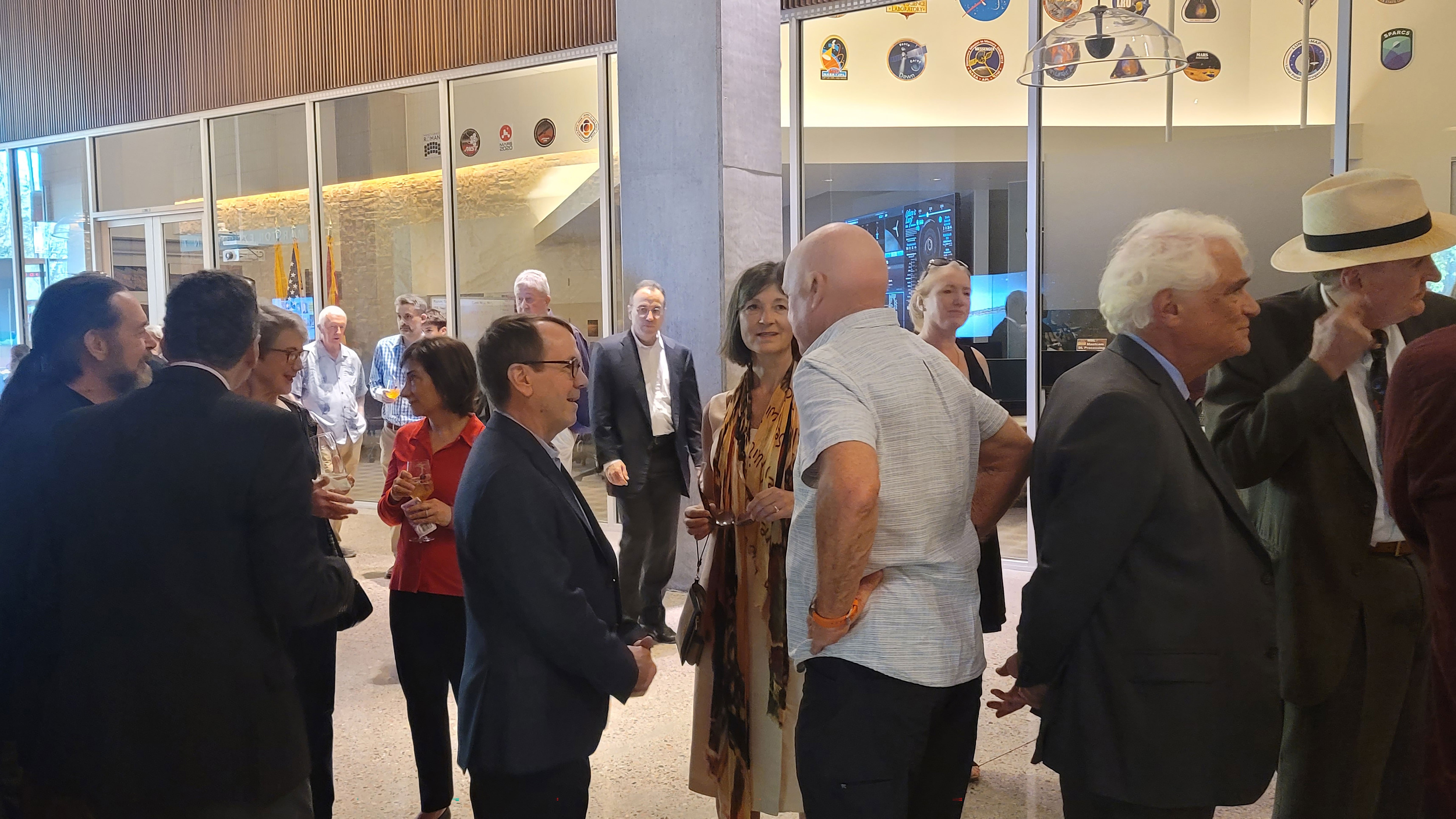 Group of people mingling in lobby for memorial