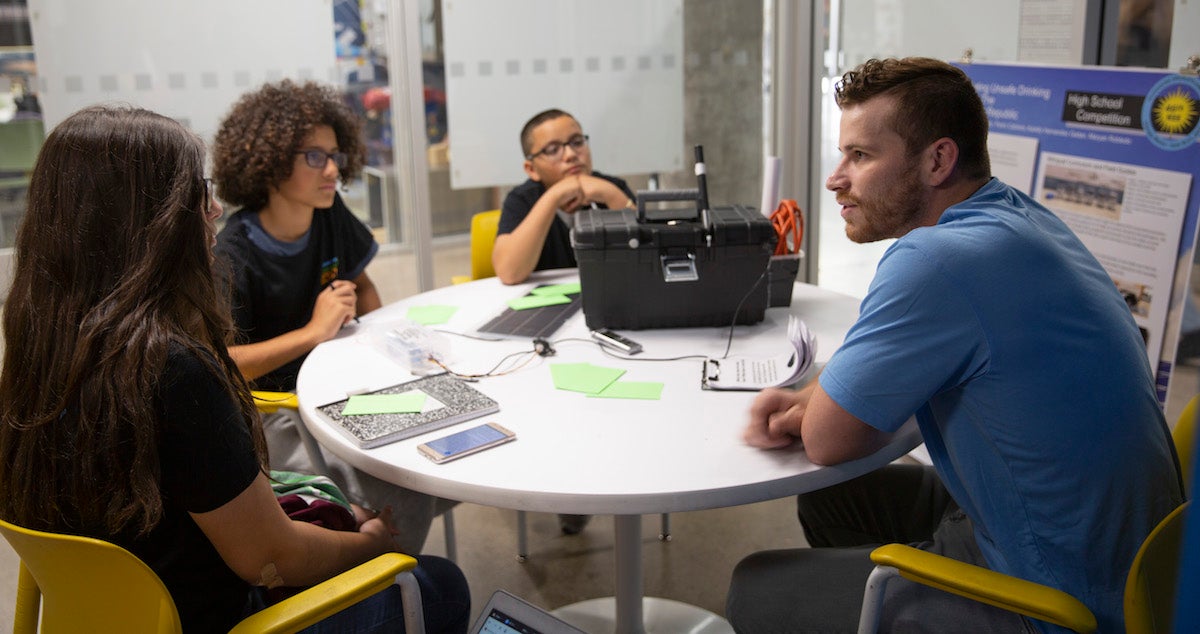 group of people sitting around table