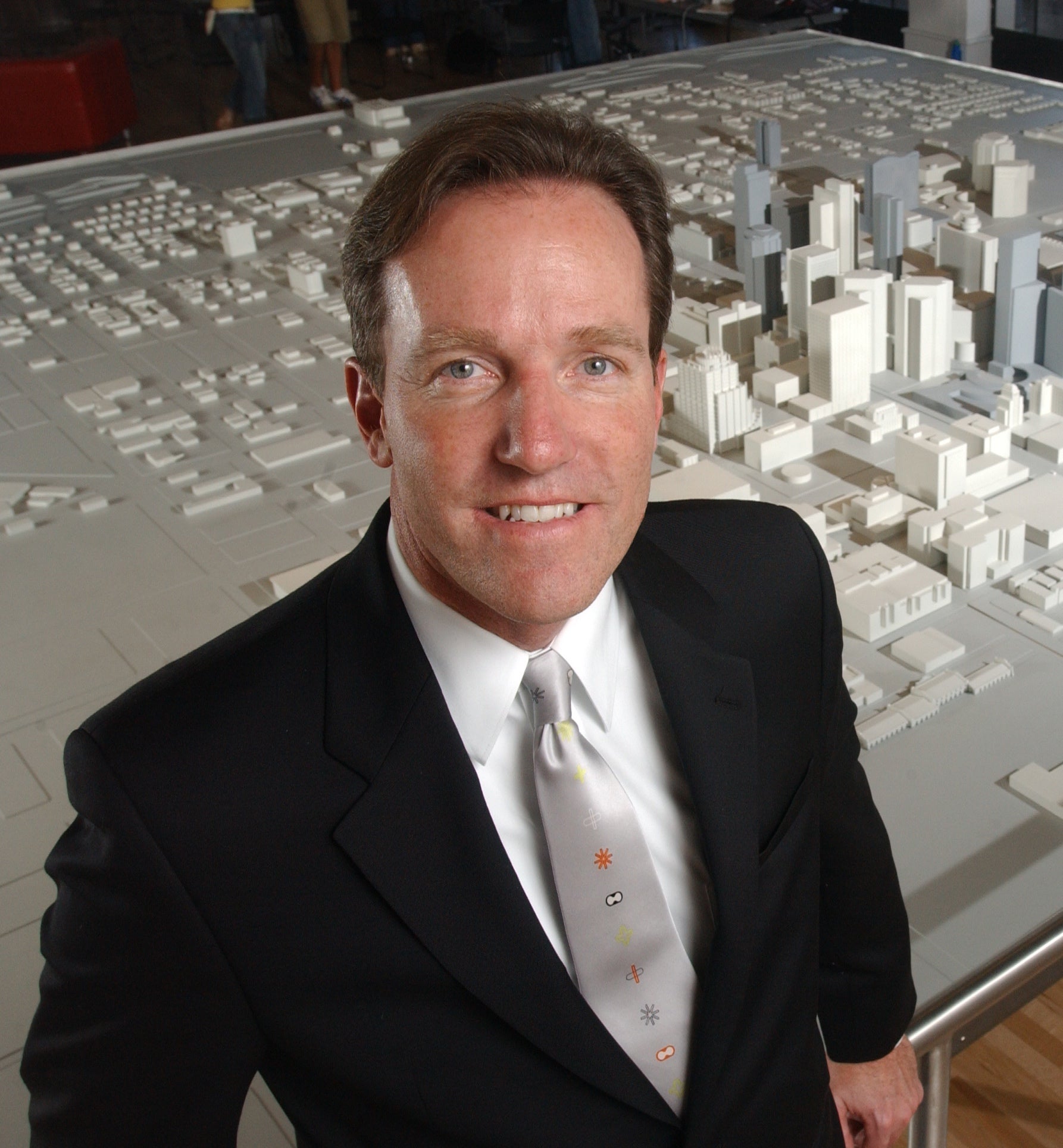 Man in black coat and gray tie