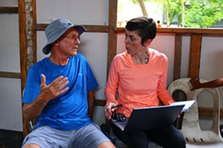 Researchers seated next to each other having a discussion.