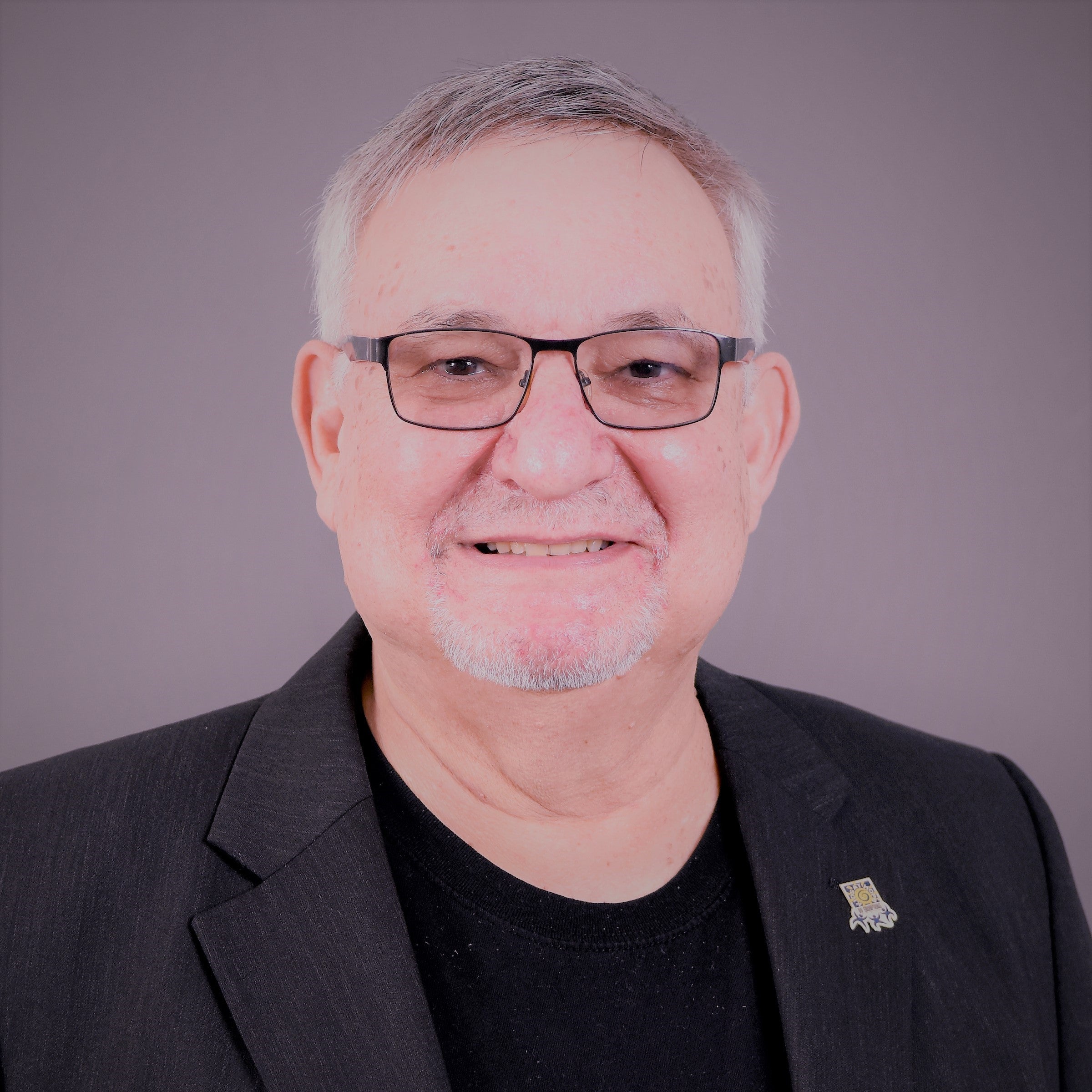 Man in glasses and black shirt and jacket