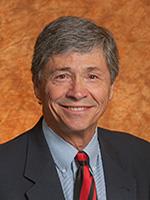 Man in red tie smiling