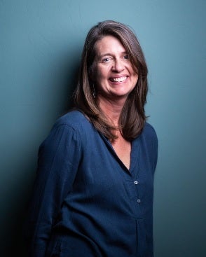 portrait of  smiling and wearing a blue shirt