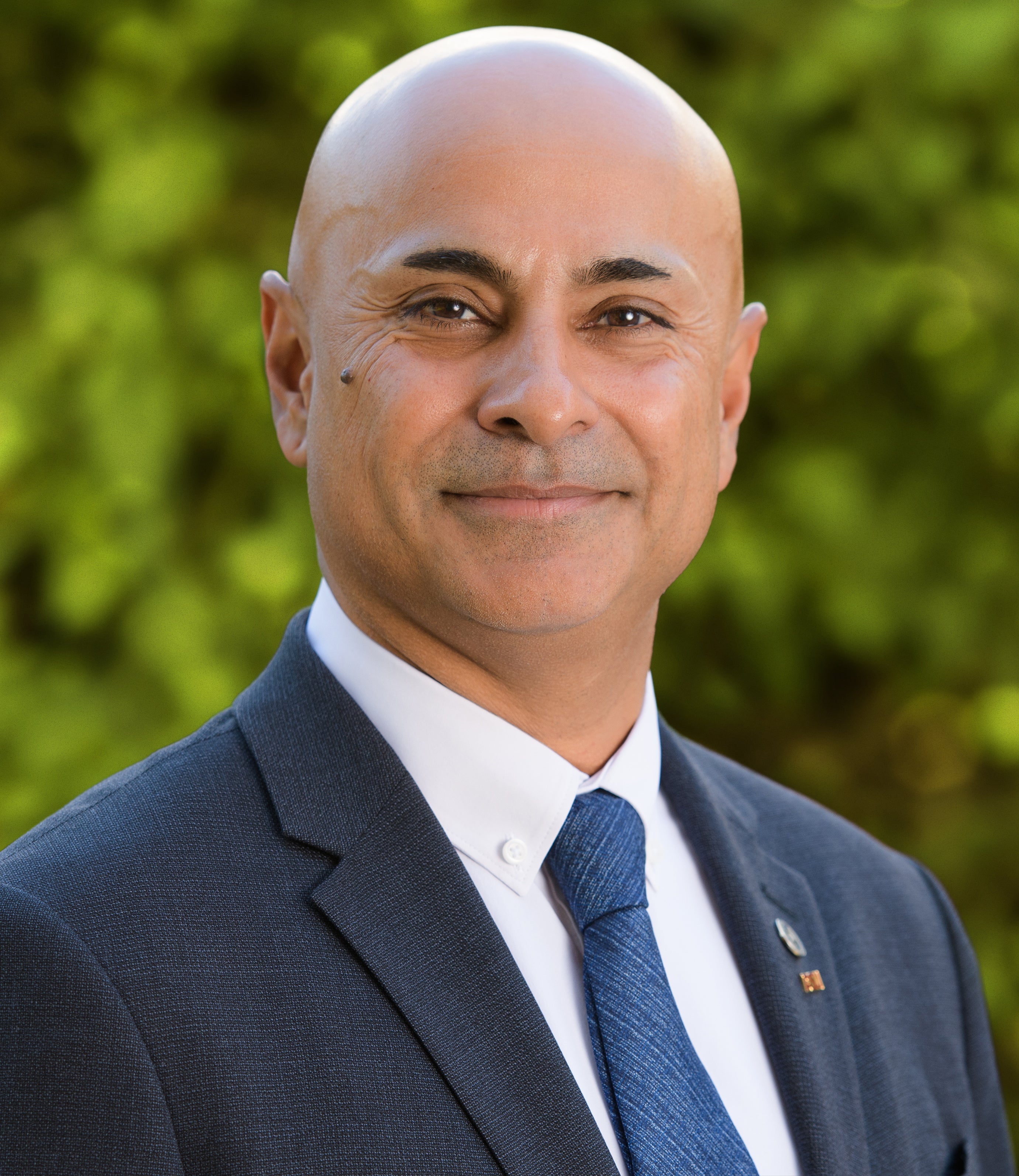 Man in blue tie with smile