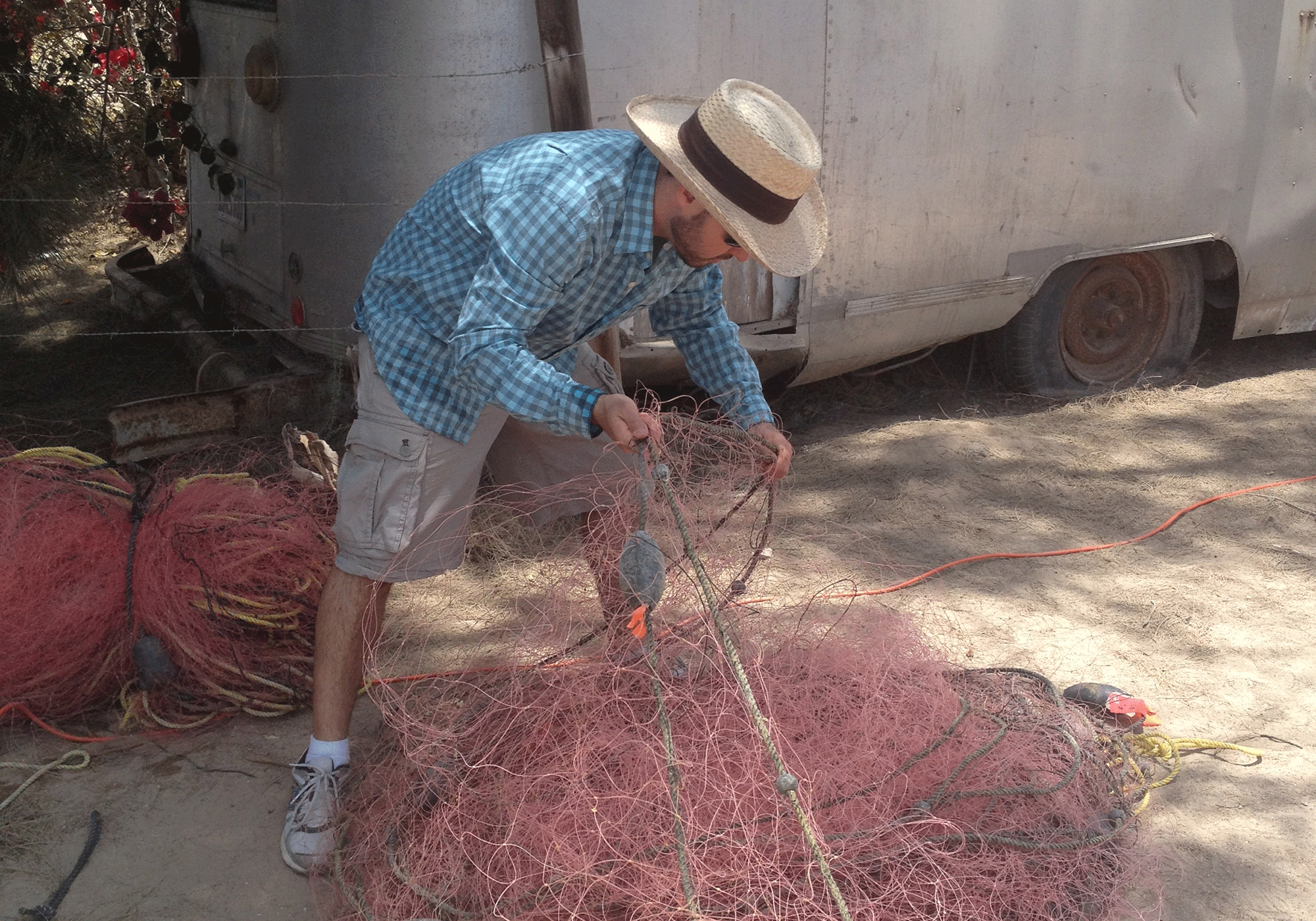 Jesse Sanko works on fishing nets