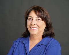 Woman in blue shirt smiling