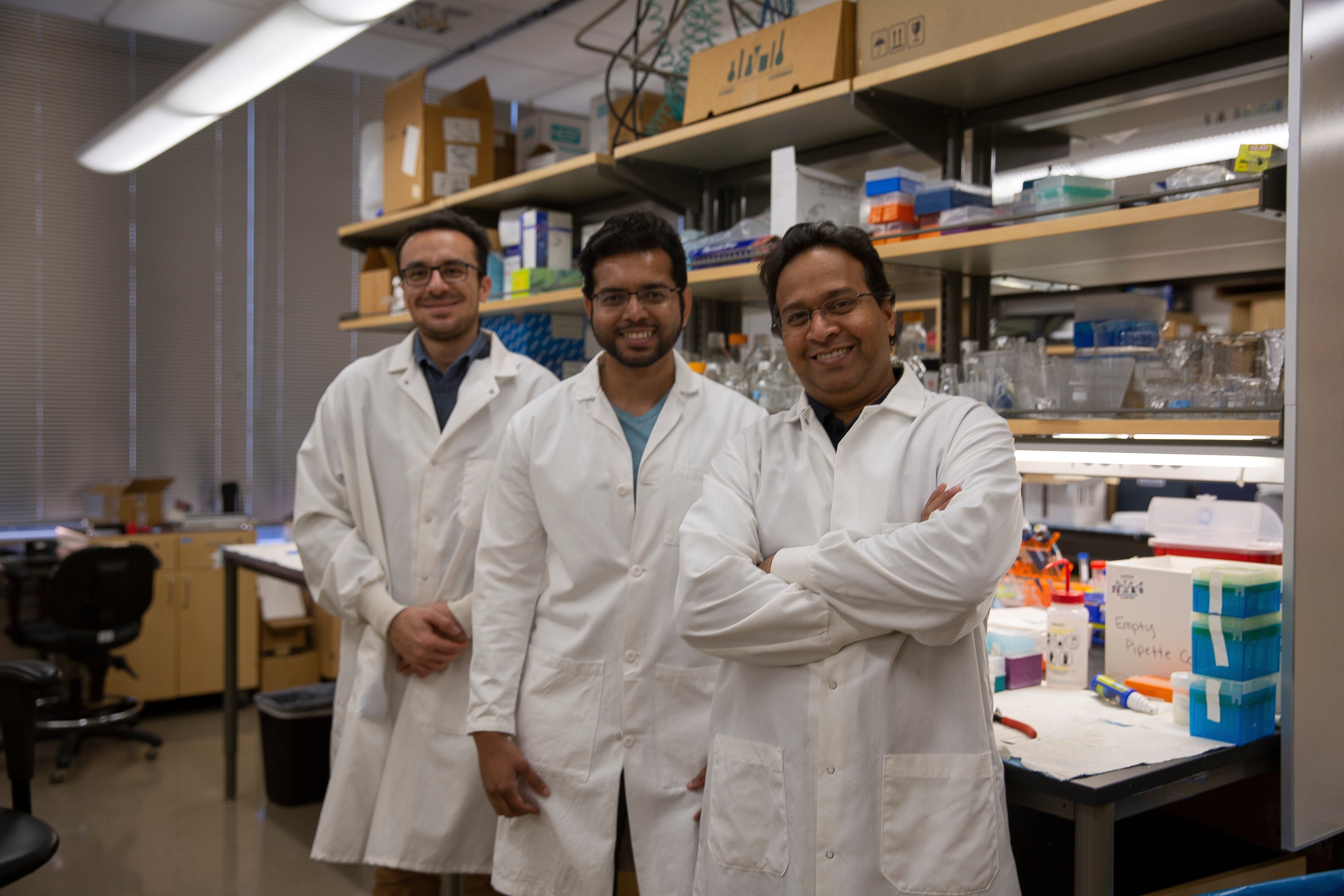 Graduate student work with a professor in his lab