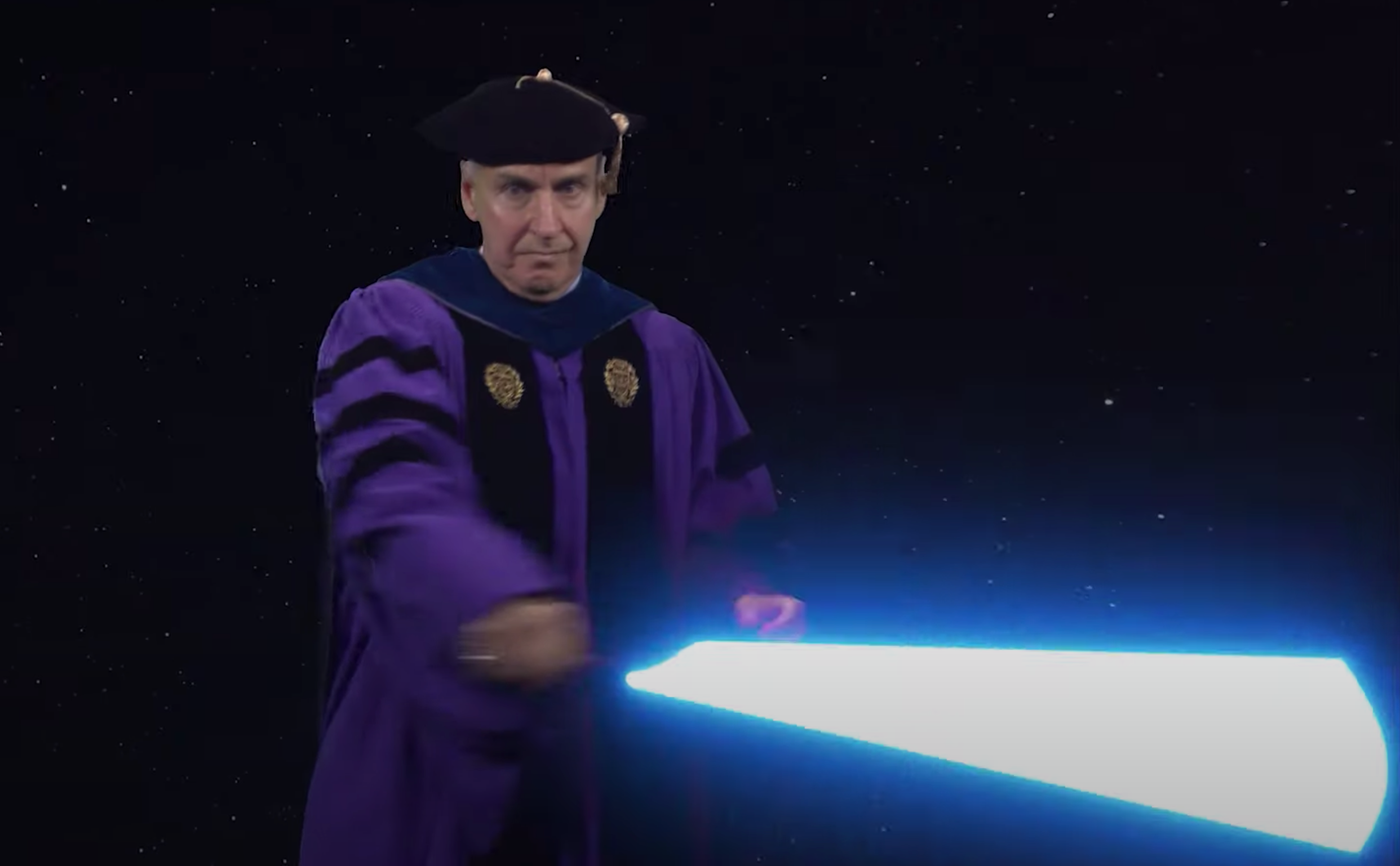 Vice Dean James Collofello yields a lightsaber