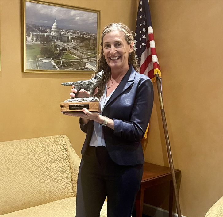 ASU Professor Leah Gerber holding the Spirit of Defenders Award.