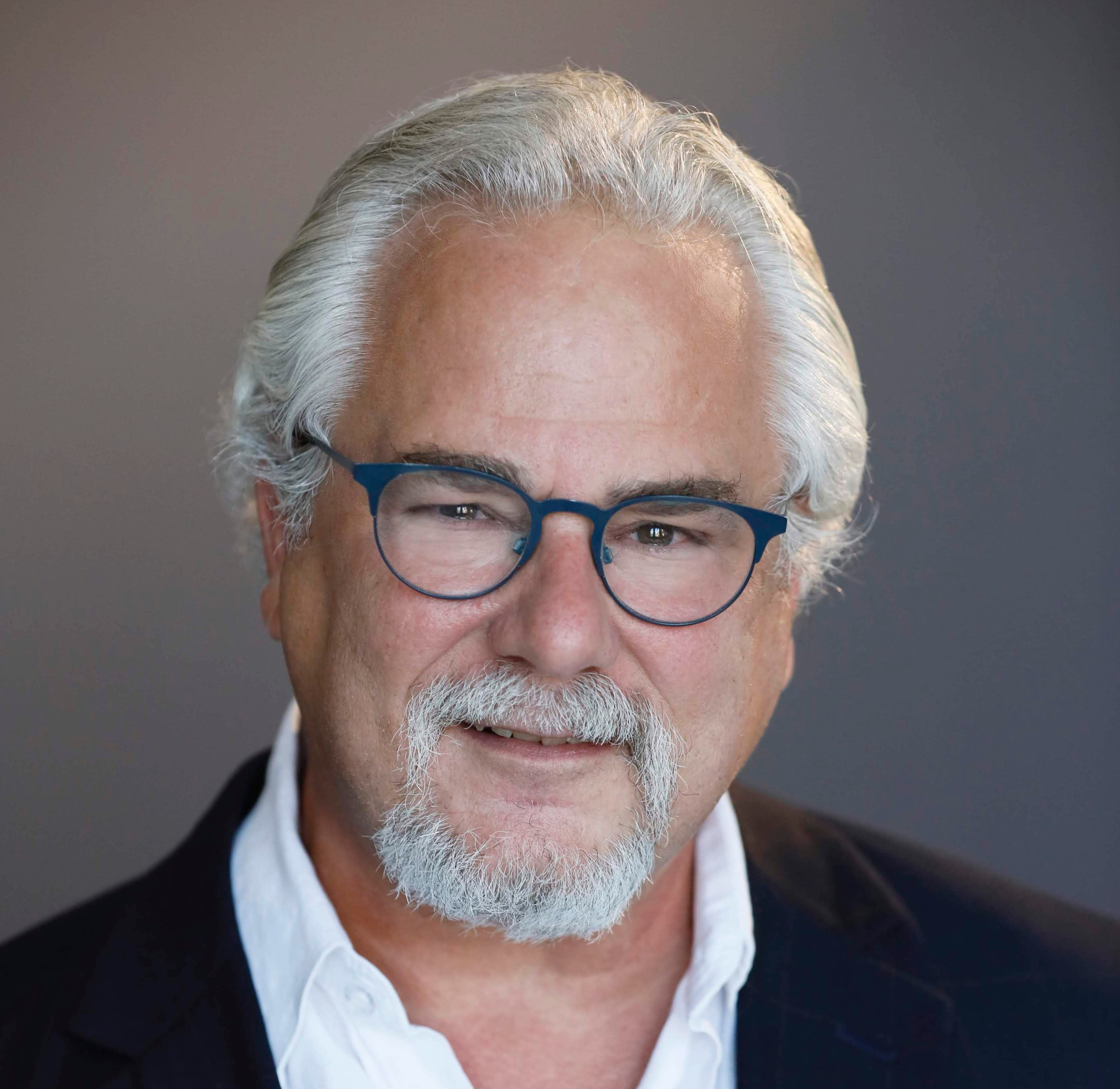 Man in silver hair and glasses