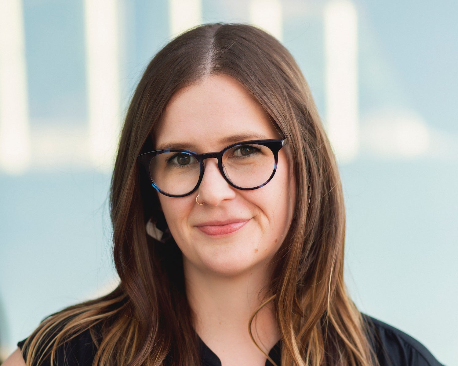 Woman with brown hair and glasses