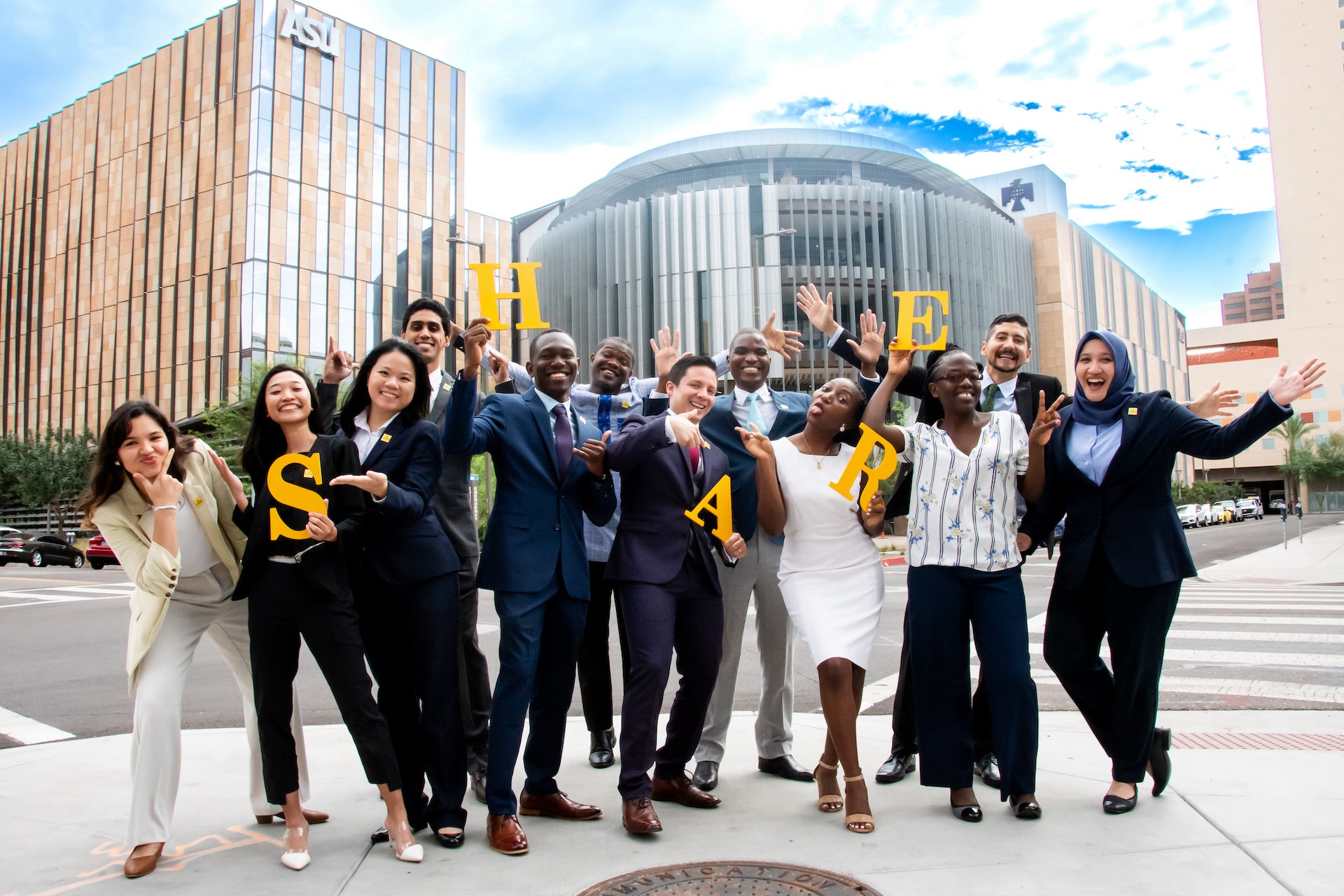 Thunderbird SHARE Fellows celebrating in front of the F. Francis and Dionne Najafi Thunderbird Global Headquarters in downtown Phoenix.