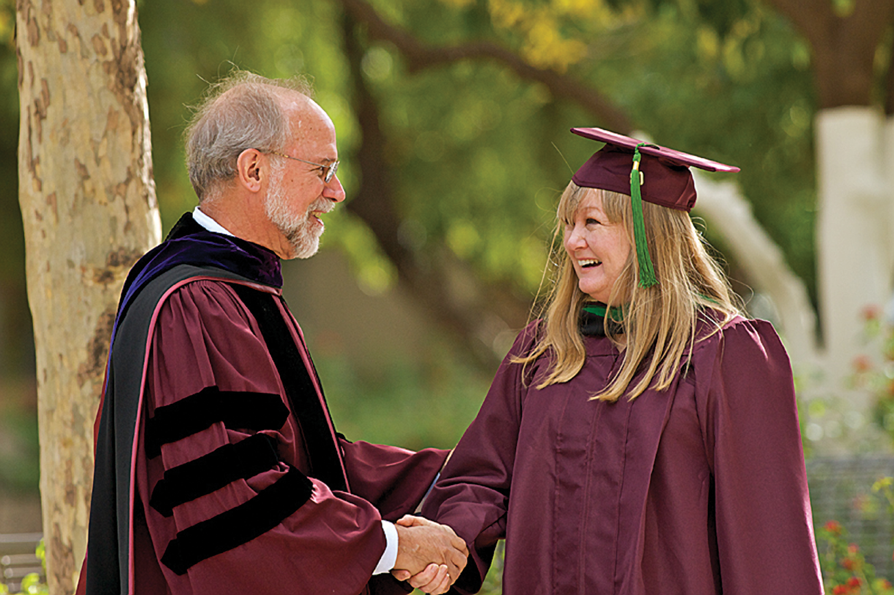 Dr. Charles Redman welcomes the first School of Sustainability graduate.