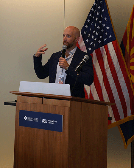 A man speaks at a lectern