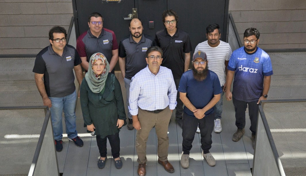 Photo of Hasan Ozer and his graduate pavement research students. 