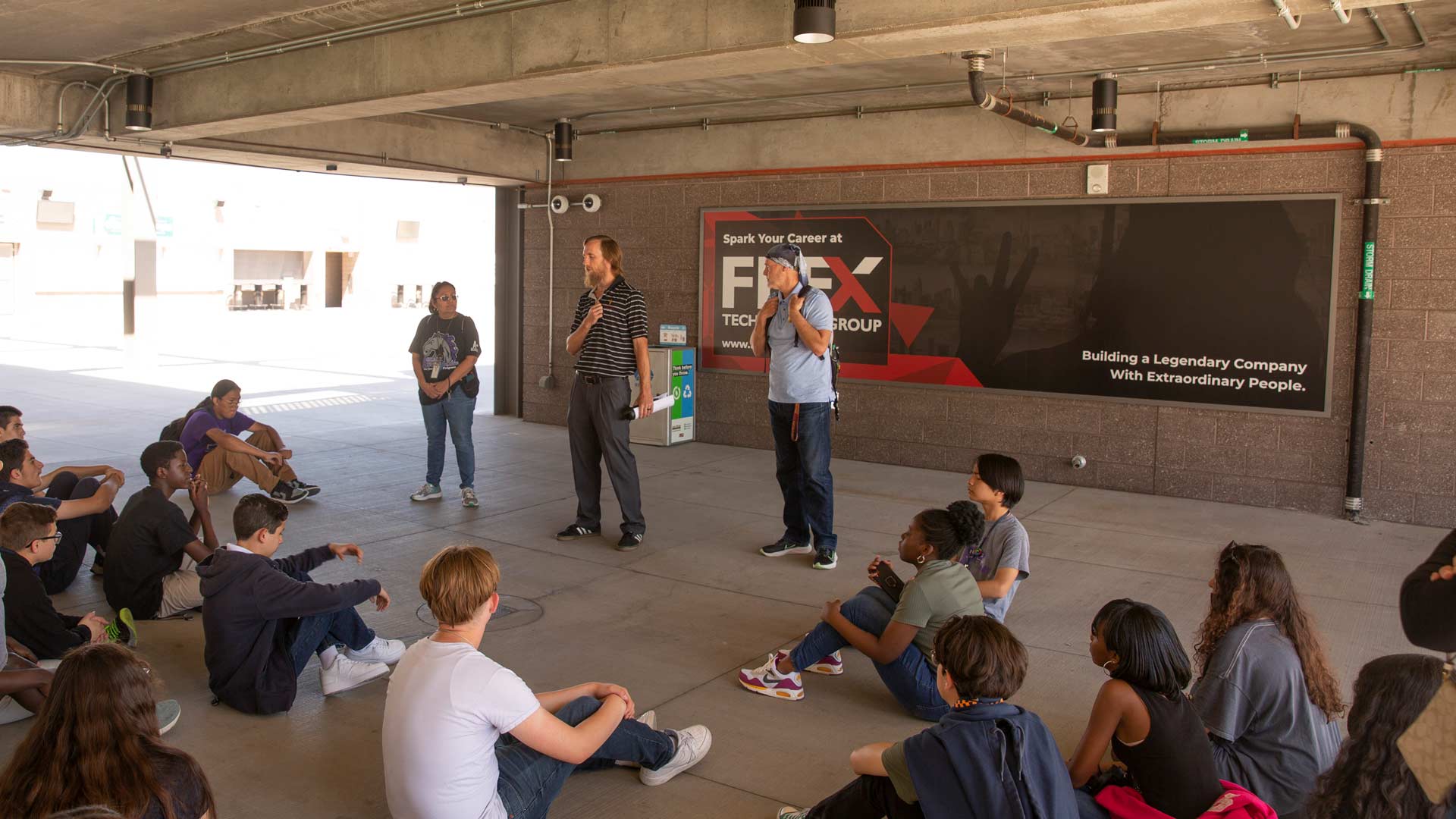 Students sit in Sun Devil Stadium tunnel on field trip