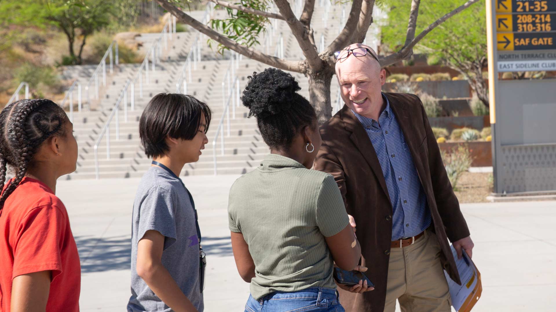 Greg Haggerty shaking hands with students