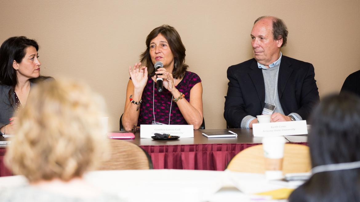 people speaking on panel at conference