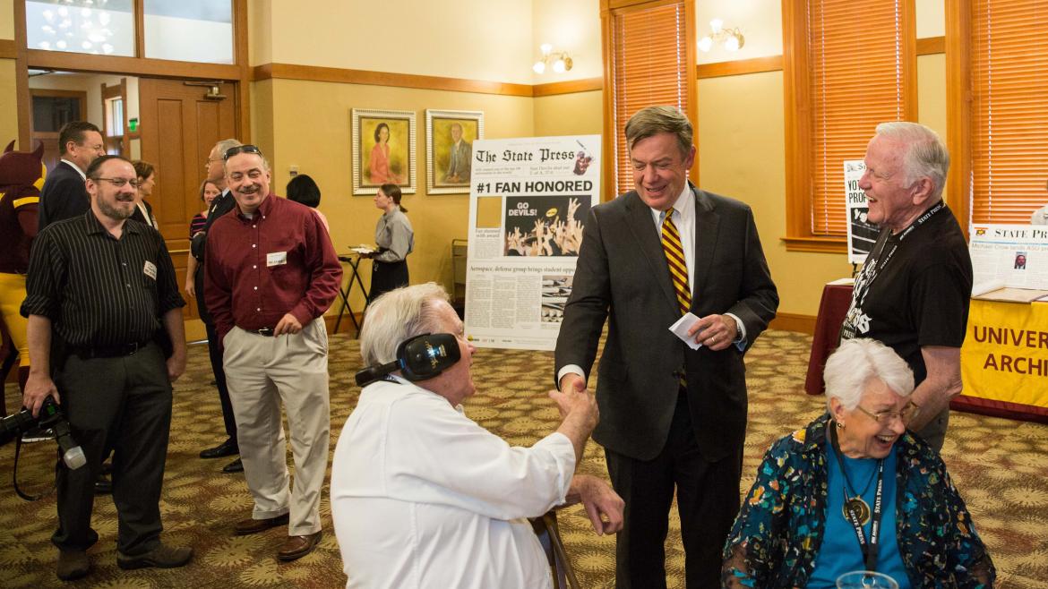 two men shaking hands at reunion