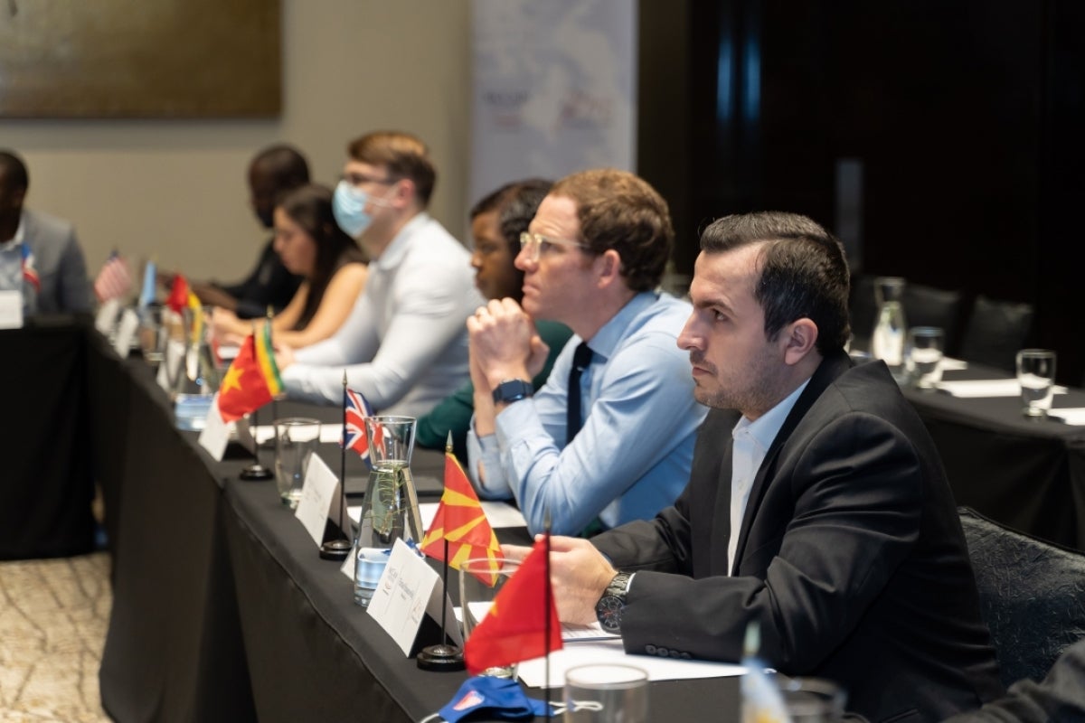 MGLs Baccus Roberts, Andrea Villagrán, Tomas Martinaitis, Angeline Makore, James Gough, and Elmas Hasanovikj listen to a discussion.