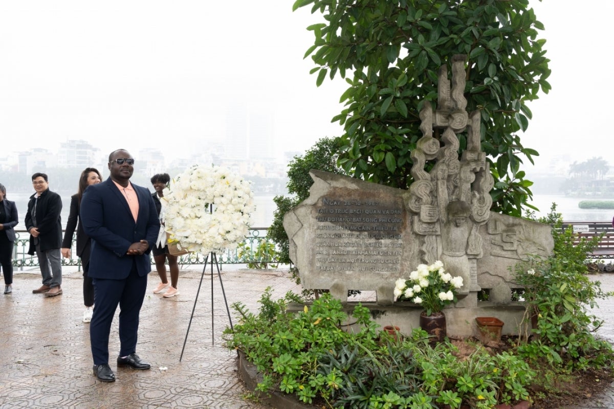 MGL Baccus Roberts of Liberia next to the John S. McCain Memorial.