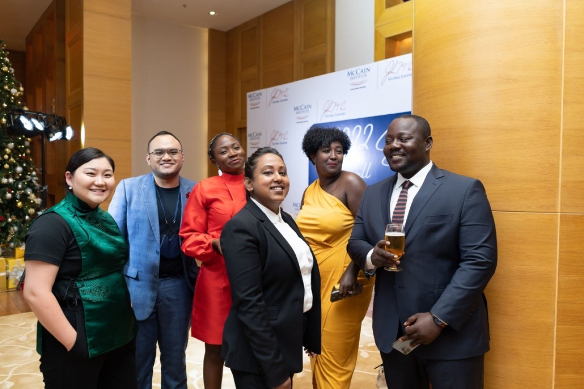 MGLs Dulamkhorloo Baatar, Ferth Vandensteen Manaysay, Zyh Akumahwah, Lemona Chanda, Wubrest Fantahun, and Baccus Roberts, attend the reception and smile for a photo.